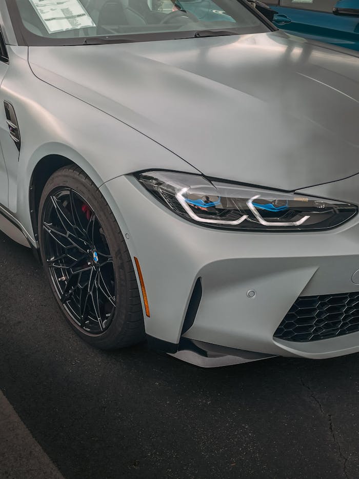 Close-up of a sleek white sport car front view in an indoor showroom.